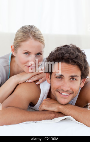 Beautiful couple lying down on their bed Stock Photo