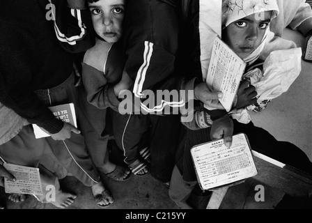Jabalya Refugee Camp, Gaza 1988. Children waiting with food coupons at the UNRWA centre. Stock Photo