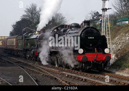 Steam engines double heading a train on the Mid-Hants Railway, - GWR Pitchford Hall behind U-class. Stock Photo