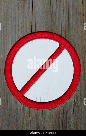 Painted Red and white no entry sign carved into wood Stock Photo