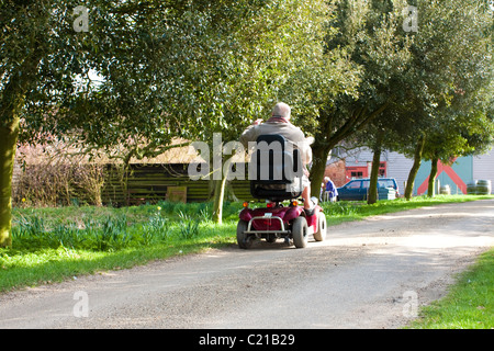 Elderly man on a mobility scooter Stock Photo