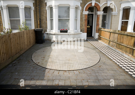 Rotating turntable platform to spin parked car for easy access to domestic driveway. Stock Photo