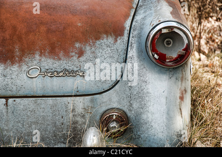 An old abandoned car in a farmer's field. Stock Photo