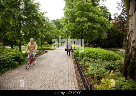 Pedestrians walking and cyclists riding through Parco Dell'Arena in Padua Italy. Stock Photo