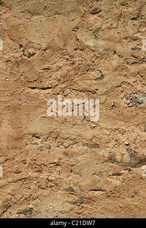 vertical image of old worn tan plastered building wall background Stock Photo