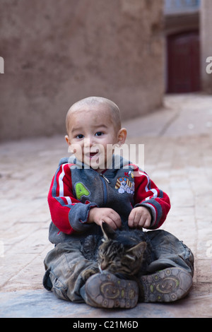 xinjiang: uighur child with cat Stock Photo