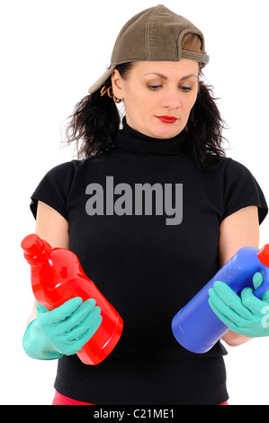 The woman in a cap and green gloves examines a washing-up liquid Stock Photo