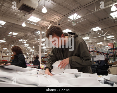 A man browsing through mens shirts at Costco Wholesale, a USA big box chain store, March 24, 2011, Katharine Andriotis Stock Photo