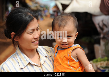 Happy dad carries serious podgy cute son. Stock Photo