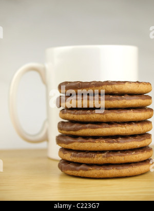 Mug of coffee and a pile of chocolate biscuits Stock Photo