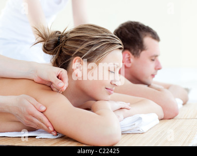 Loving couple having an acupunctre therapy Stock Photo