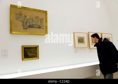 Tourist views painting / picture on bull fight / bullfighter / Toreo / museum tour. Sevilla bullring / bull ring. Seville. Spain Stock Photo