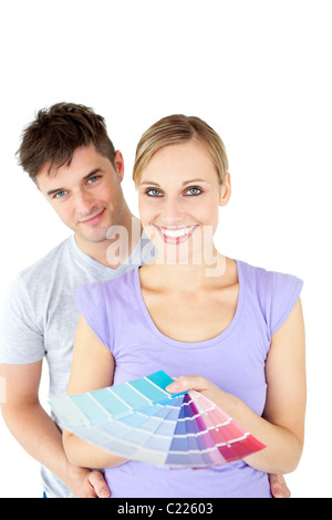 Affectionate young couple choosing colors for painting their room Stock Photo