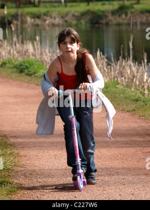 Young girl on a scooter, UK Stock Photo