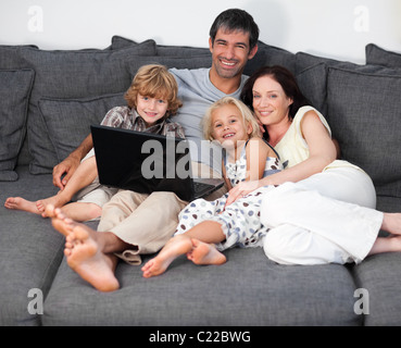 Parents and kids using a laptop Stock Photo