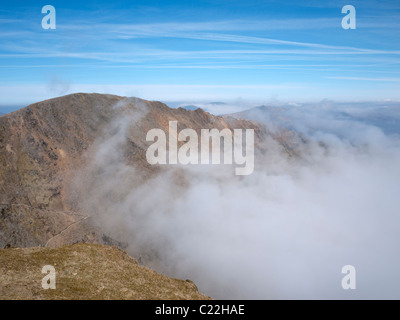 Carnedd (Garnedd) Ugain and Crib Y Ddysgl seen above a could inversion from the summit of Snowdon, North Wales Stock Photo