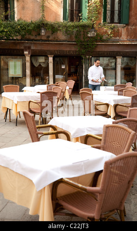 Waiter setting tables, The Theatre restaurant, (Al Teatro ristorante) Venice Italy Stock Photo