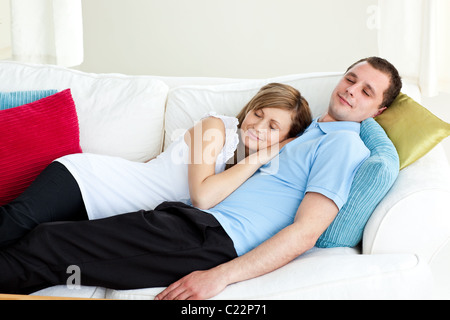 Loving couple sleeping lying on a sofa Stock Photo