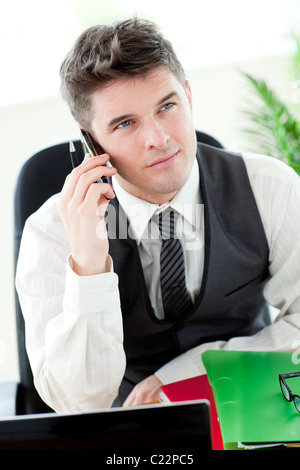 Smiling young businessman talking on phone Stock Photo
