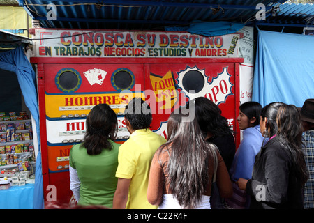 Teenagers queuing at a fortune telling machine in a fairground , La Paz , Bolivia Stock Photo