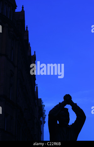 The bronze statue of Brian Clough OBE in Nottingham City Centre at night. Stock Photo