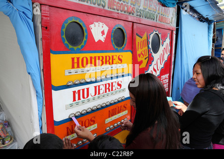 Teenage girl receiving her predictions from a fortune telling machine in a fairground , La Paz , Bolivia Stock Photo