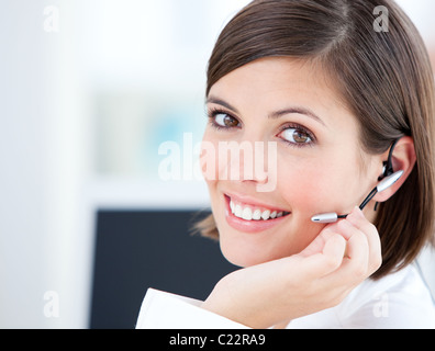 Cute businesswoman talking with clients in front of her computer Stock Photo