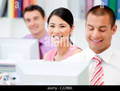 Happy business people working at a computer Stock Photo