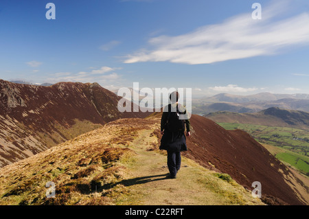 Walker on the ridge of Knott Rigg in the English Lake District, looking out towards Causey Pike and the Newlands Valley Stock Photo