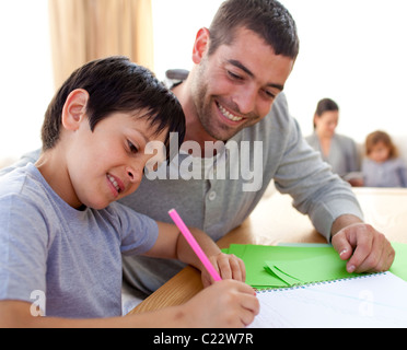 Father helping his son doing homework Stock Photo