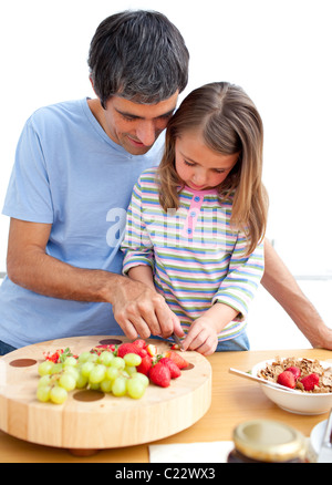 Father and his daughter having breakfast in the kitchen Stock Photo