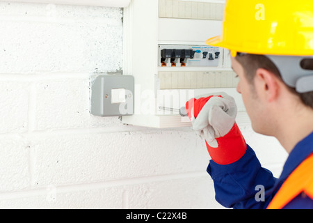 Mature electrician repairing a power plan Stock Photo