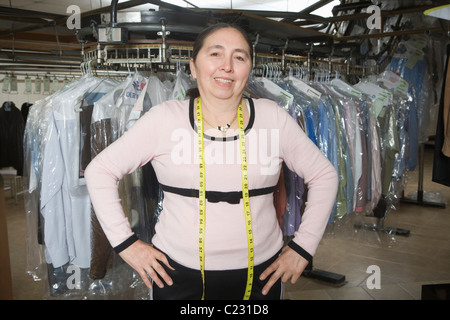 Mature woman working in laundrette Stock Photo