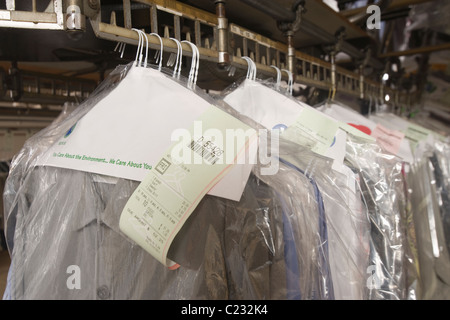 Clothes hanging in the laundrette Stock Photo