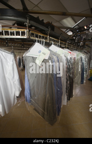 Clothes hanging in the laundrette Stock Photo