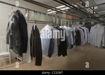 Clothes hanging in the laundrette Stock Photo