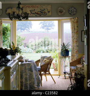 Traditional English country kitchen with patterned tablecloth and rural views Stock Photo