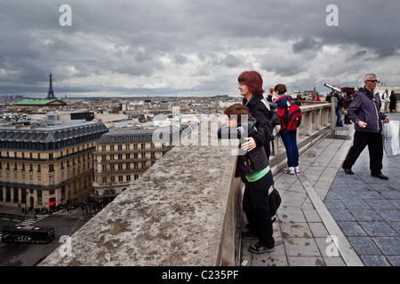 Tourists admiring the view of the Paris Skyline from the roof of Printemps. Charles Lupica Stock Photo