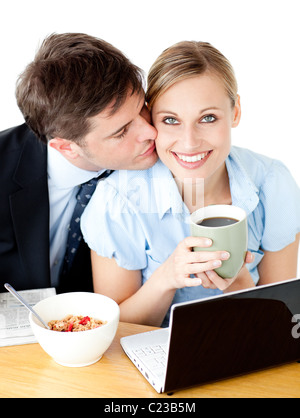 Attractive  businessman kissing his girlfriend while having breakfast Stock Photo