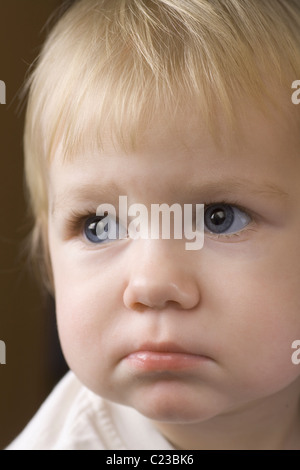 Blonde 14 month old with downcast expression Stock Photo