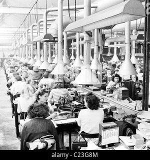 1950s, England.  Rows of female workers at the Ever Ready Battery factory in this picture by J Allan Cash. Stock Photo