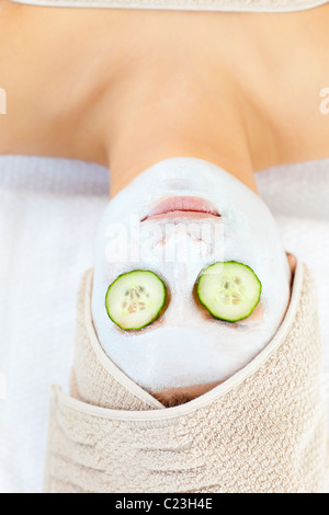 Beautiful young woman with flower relaxing in spa salon Stock Photo - Alamy