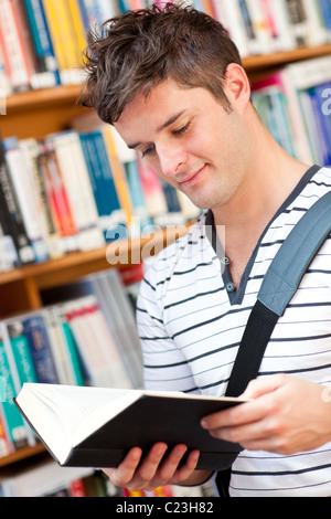 Cute male student reading a book Stock Photo