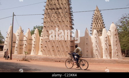 A cyclist passes the Grande Mosquée in Bobo Dioulasso Stock Photo