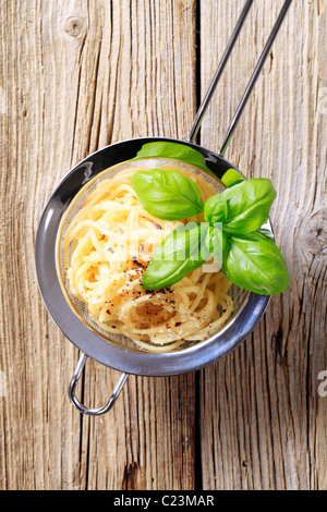 Spaghetti sprinkled with parmesan and vegetable seasoning Stock Photo