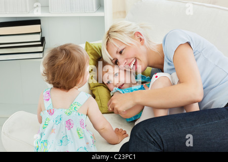 Woman is hugging her daughter Stock Photo