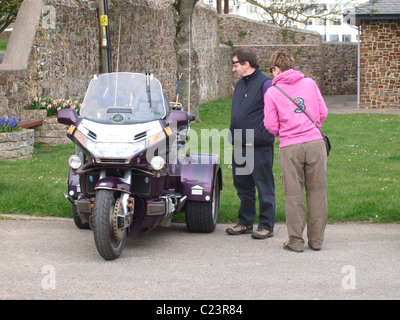 Couple admiring a Honda Goldwing trike, Bude, Cornwall, UK Stock Photo