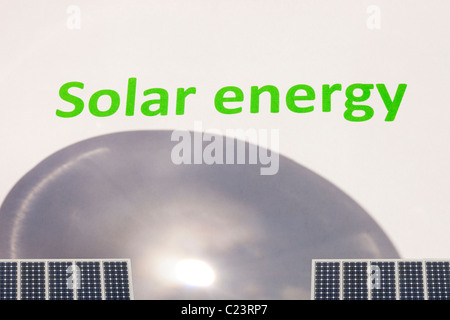 Solar power, concentrating the suns power through a magnifying glass and solar panels Stock Photo