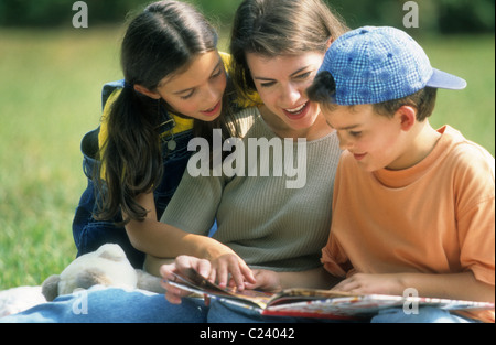 Mother reading with her children. Stock Photo