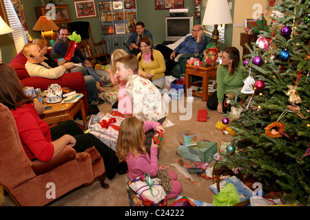 Family opening and giving presents to each other on Christmas day Stock Photo